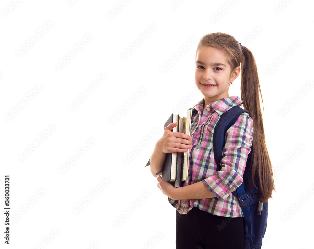Adorable schoolgirl with long hairs and books in hands Adorable schoolgirl with long hairs and books in hands