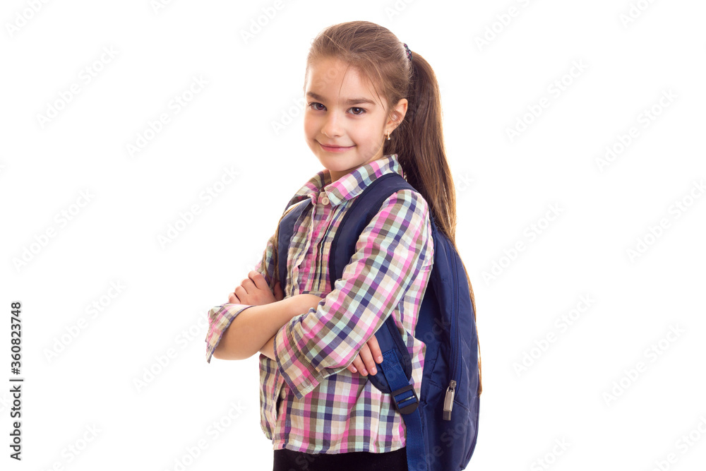 Girl with schoolbag and crossed hands looking in camera. Girl with schoolbag and crossed hands looking in camera.