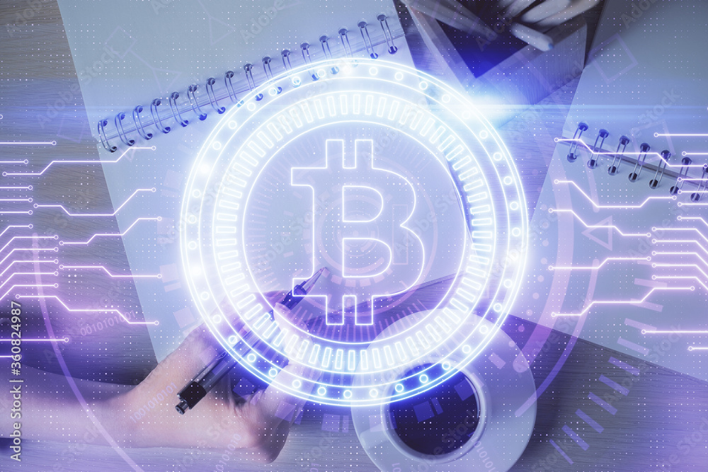 Cryptocurrency hologram over woman's hands writing background. Concept of blockchain. Double exposure Cryptocurrency hologram over woman's hands writing background. Concept of blockchain. Double exposure