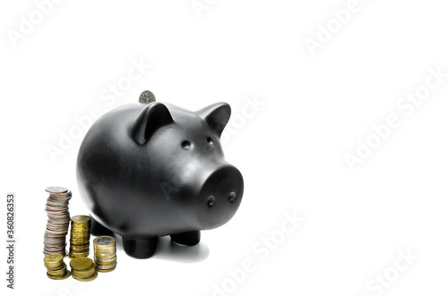 Piggy bank and a stack of coins nearby