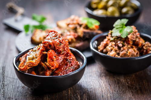 Sun dried tomato with olive oil as antipasto photo