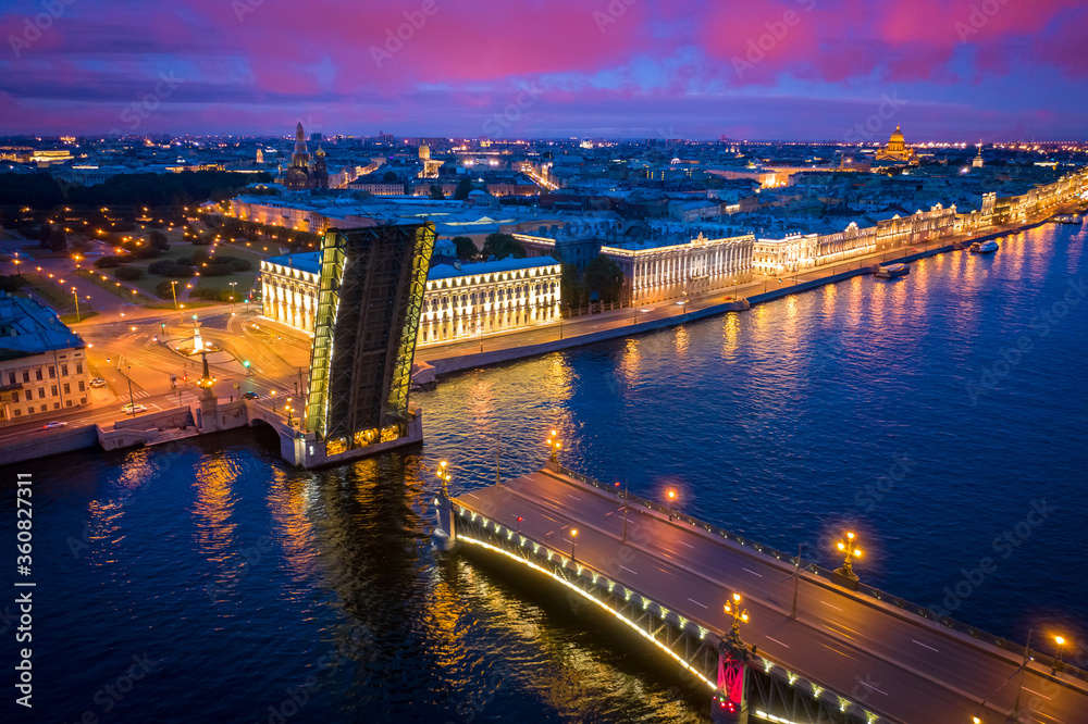 Fototapeta premium Saint Petersburg. Russia. Trinity bridge in the night city. Raised bridge in the night St. Petersburg. Panorama of evening Petersburg. Cities of Russia top view. City night lights. Traveling in Russia