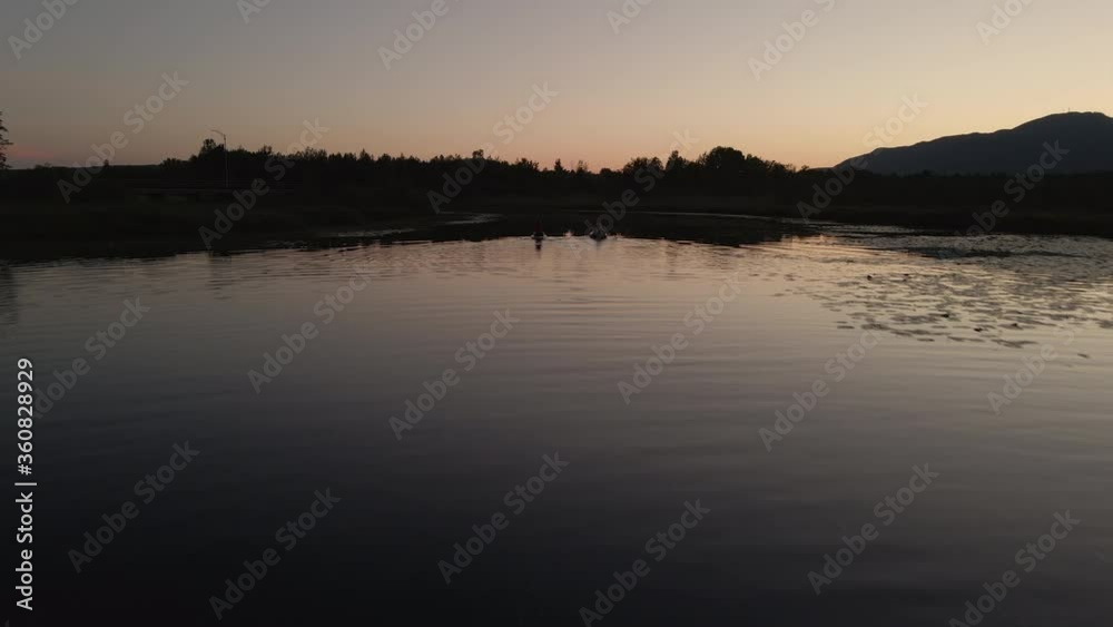 Dramatic Sunset Over The Cherry River With Reflections And People Kayaking During Summer In Magog, Quebec, Canada. -aerial drone Dramatic Sunset Over The Cherry River With Reflections And People Kayaking During Summer In Magog, Quebec, Canada. -aerial drone
