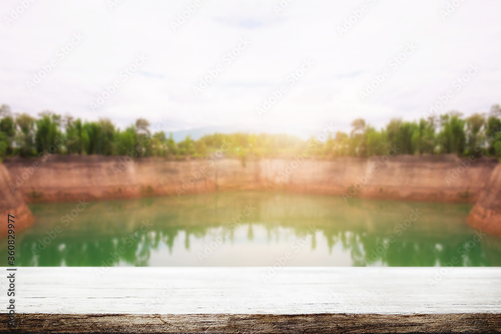 Empty wooden desk space platform and blurred field lake background for product display montage. Empty wooden desk space platform and blurred field lake background for product display montage.