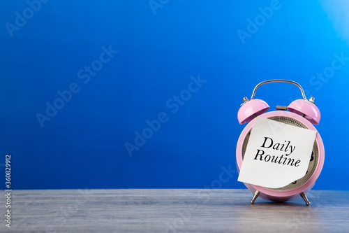 Alarm clock and daily routine words on sticker note paper photo