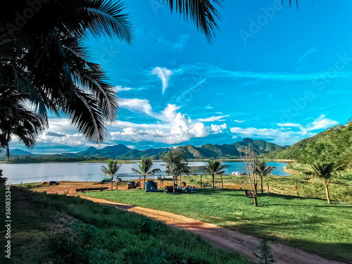 camping zone with a mountain view and blue sky at Lam Taphoen Reservoir, Suphan Buri, Thailand photo