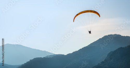 Paraglider in the sky against the background of mountains
