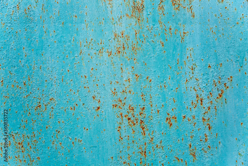 Rusty surface of a turquoise sheet of iron. Background. Space for text.