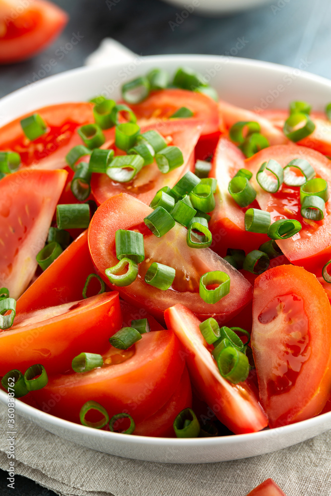 Tomato salad with spring onion and herbs in white bowl. Healthy summer food Tomato salad with spring onion and herbs in white bowl. Healthy summer food