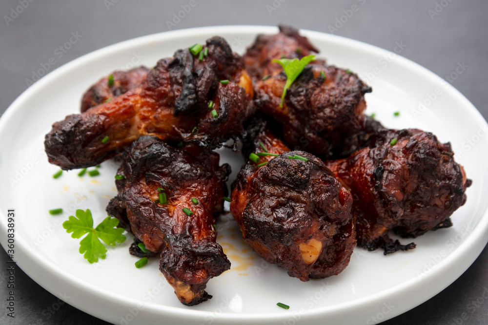 Barbecue roasted chicken legs, wings, drumsticks on plate, isolated. Barbecue roasted chicken legs, wings, drumsticks on plate, isolated.