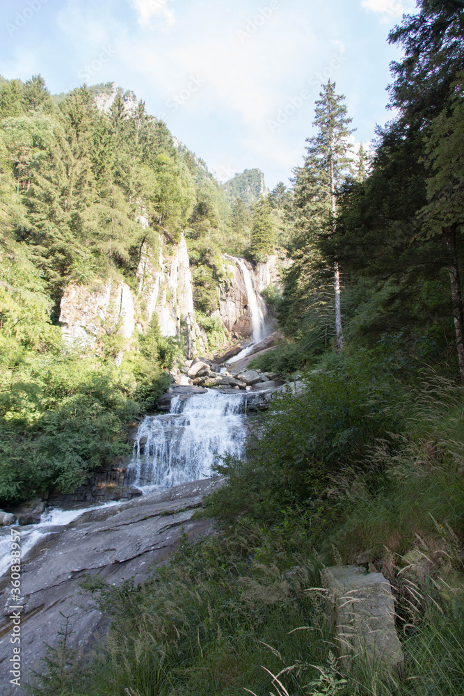 Mountain waterfall Salt de Rebet in forest, Braone Valley, Italy.