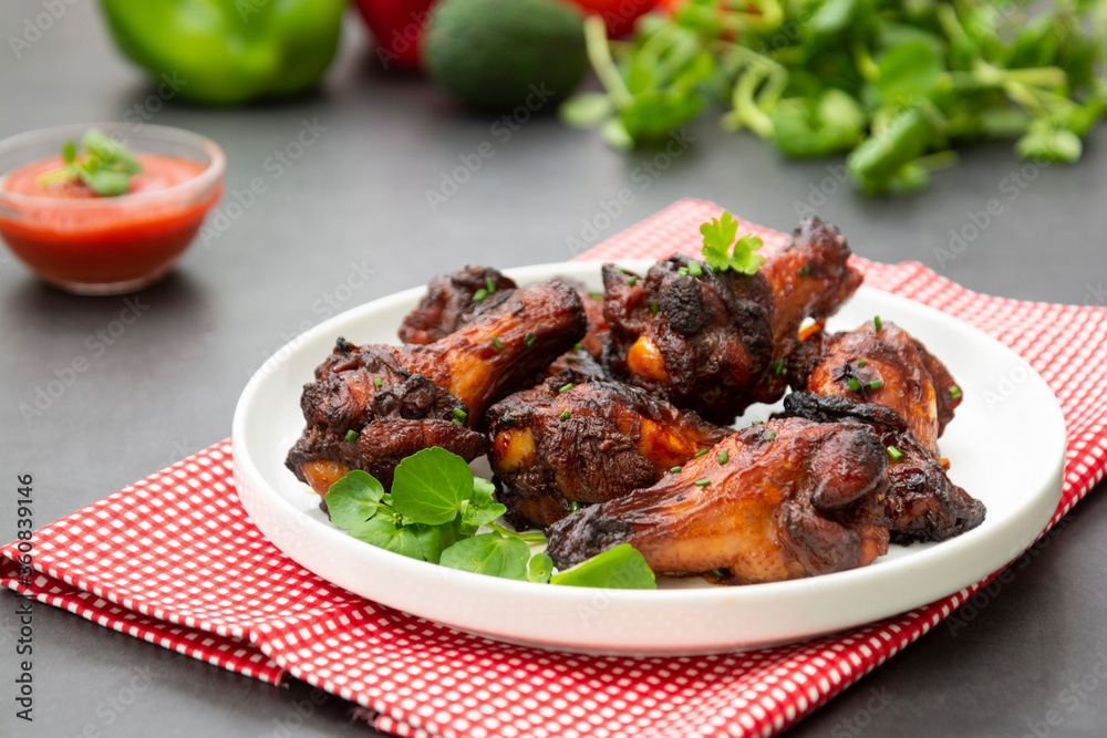 Roasted chicken legs, drumsticks on plate with fresh vegetables. Roasted chicken legs, drumsticks on plate with fresh vegetables.