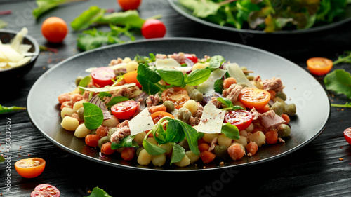 Mini potato gnocchi tricolour with tomato  spinach  Seasonal salad leaves and parmesan cheese