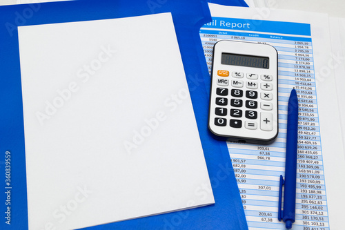 business office desk closeup - financial reports, analysis and accounting, set of documents, tables and graphs, various items for bookkeeping, calculator