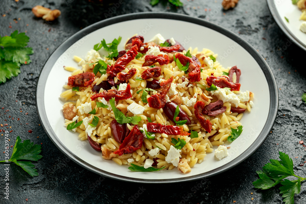 Orzo Pasta with sunshine dry tomato, black olives, walnut and feta cheese Orzo Pasta with sunshine dry tomato, black olives, walnut and feta cheese