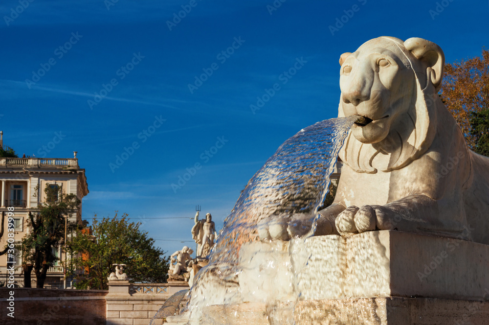 Marble egyptian lion from Piazza del Popolo central fountain, erected in 1823, one of the most important and ancient square in Rome, with Neptune statue in the background
