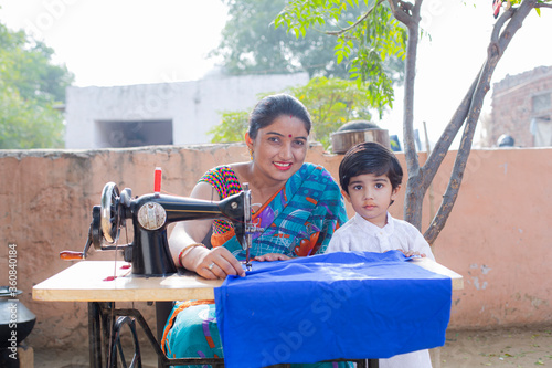 Photography Mother and boy sewing clothes with sewing machine