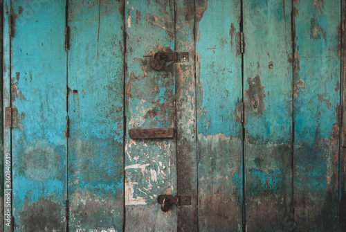 An old teal coloured wooden door