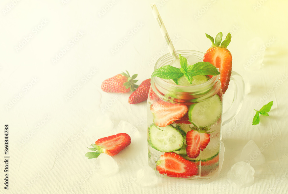 Summer refreshing iced drinks with cucumber and strawberry on white background