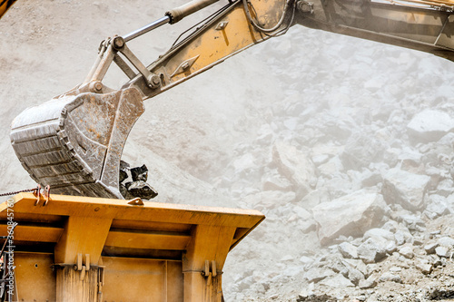 details of track type excavator industrial scoop. engineer working with excavator at construction site