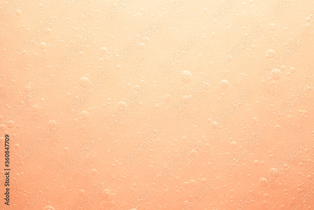 Liquid gel cosmetic serum smudge yellow orange background