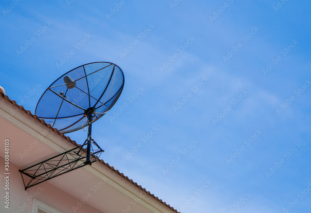 satellite dish on the roof  with blue sky in background