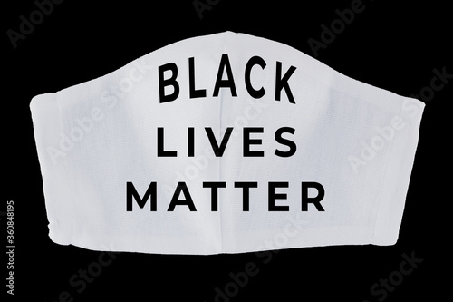 Black Lives Matter on face mask. White protective mask on black background. Concept of protest against racism and violence. Isolated