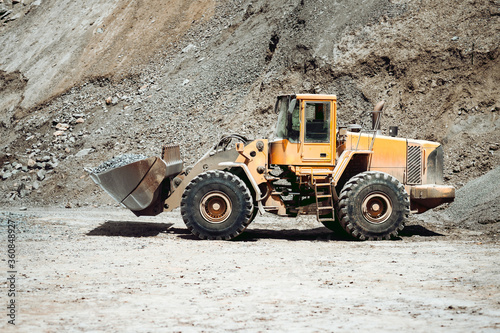 Large wheel loader on construction site transporting gravel