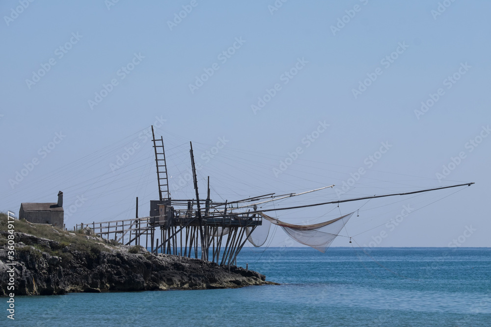 Typical traditional fishing trabucco at the beach of Viestealong the Adriatic Sea in Puglia, Italy, Europe. 