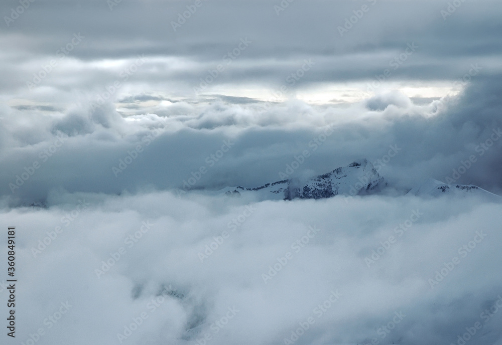 Cloudy winter mountainous landscape. The greater Caucasus mountain range. Gudauri ski resort. Georgia.