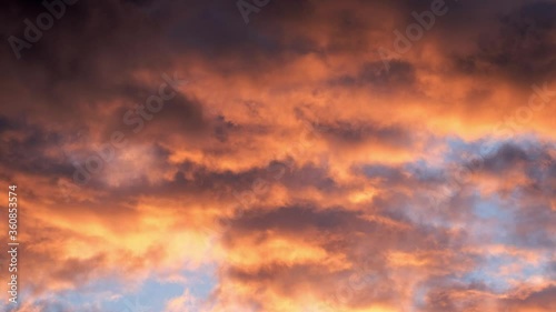 4K timelapse loops with dramatic orange sunset on dark cloudy sky