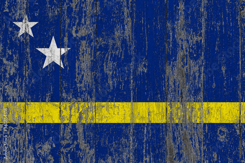 Curacao flag on grunge scratched wooden surface. National vintage background. Old wooden table scratched flag surface. photo
