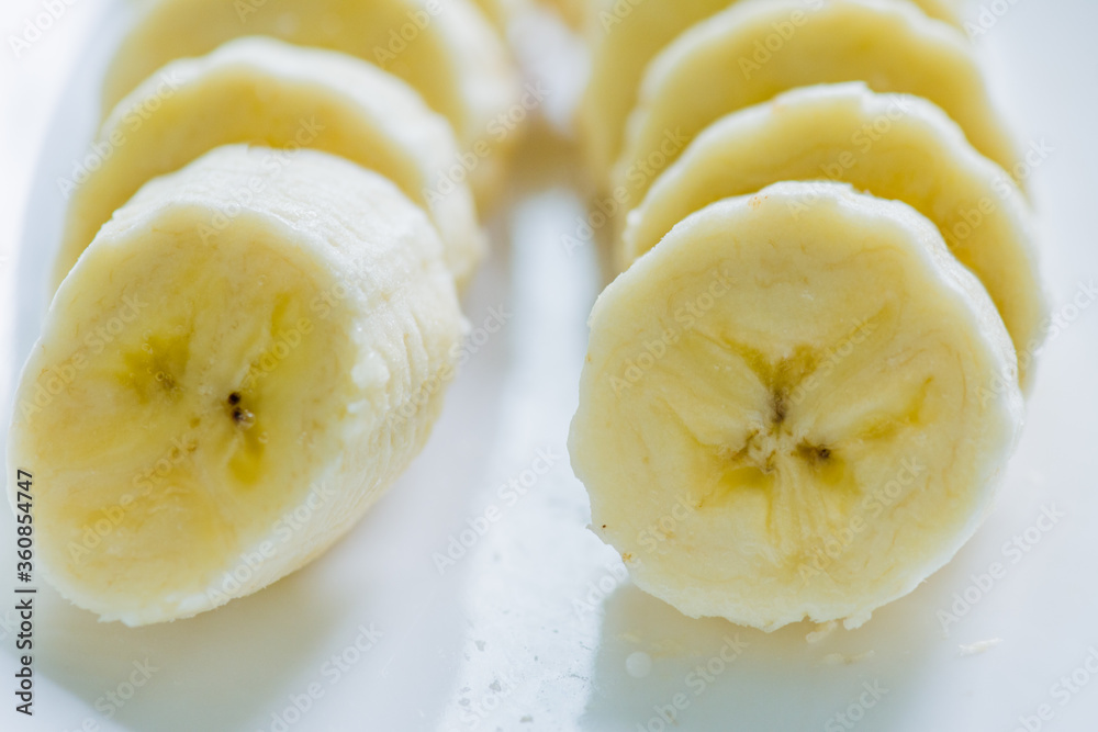 Sliced banana on white dish Sliced banana on white dish