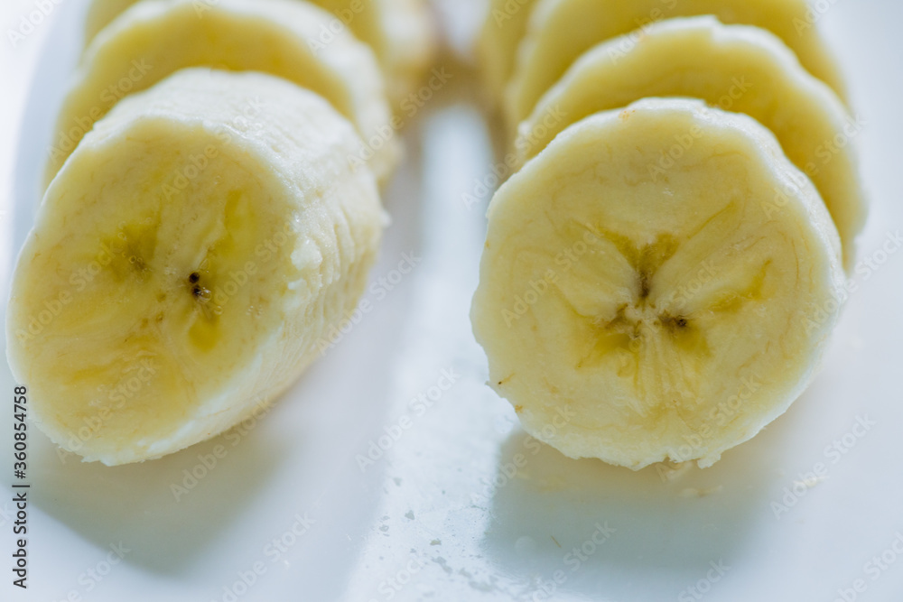 Sliced banana on white dish Sliced banana on white dish