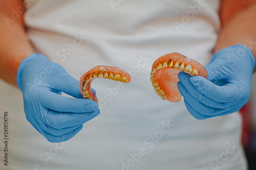 Broken acrylic denture. Dental phantom. Selective focus photo.