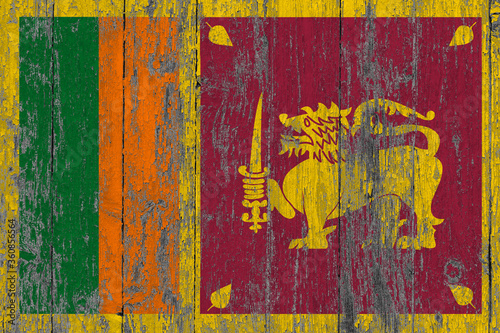 Sri Lanka flag on grunge scratched wooden surface. National vintage background. Old wooden table scratched flag surface.