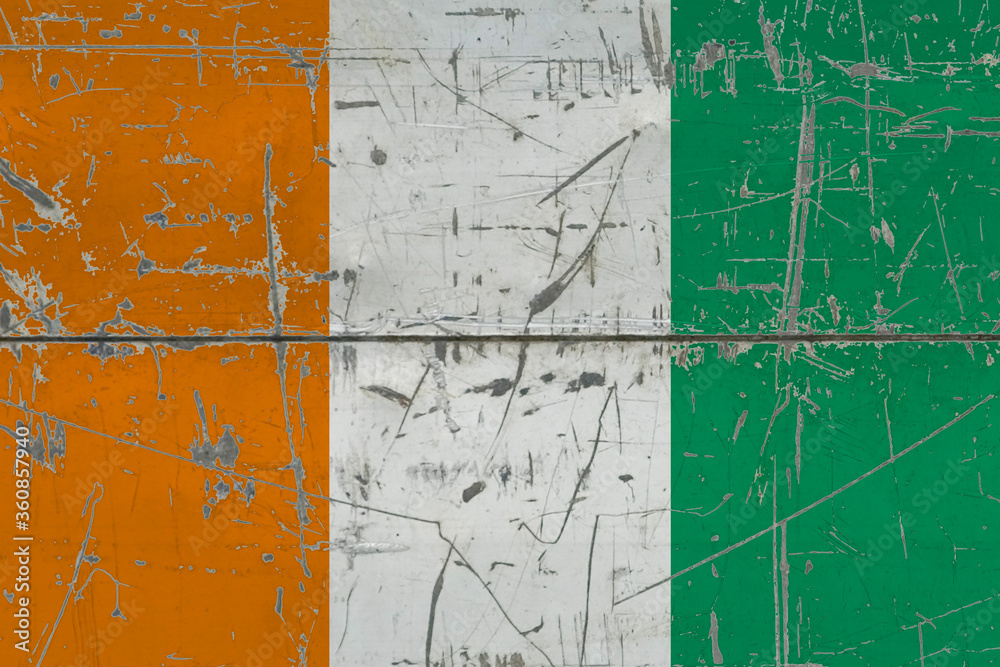 Cote D'Ivoire flag painted on cracked dirty surface. National pattern on vintage style surface. Scratched and weathered concept.