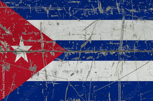 Cuba flag painted on cracked dirty surface. National pattern on vintage style surface. Scratched and weathered concept.