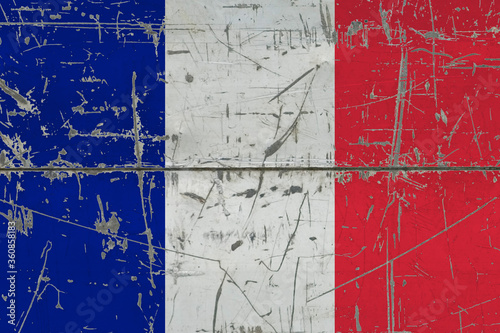 France flag painted on cracked dirty surface. National pattern on vintage style surface. Scratched and weathered concept. © sezerozger