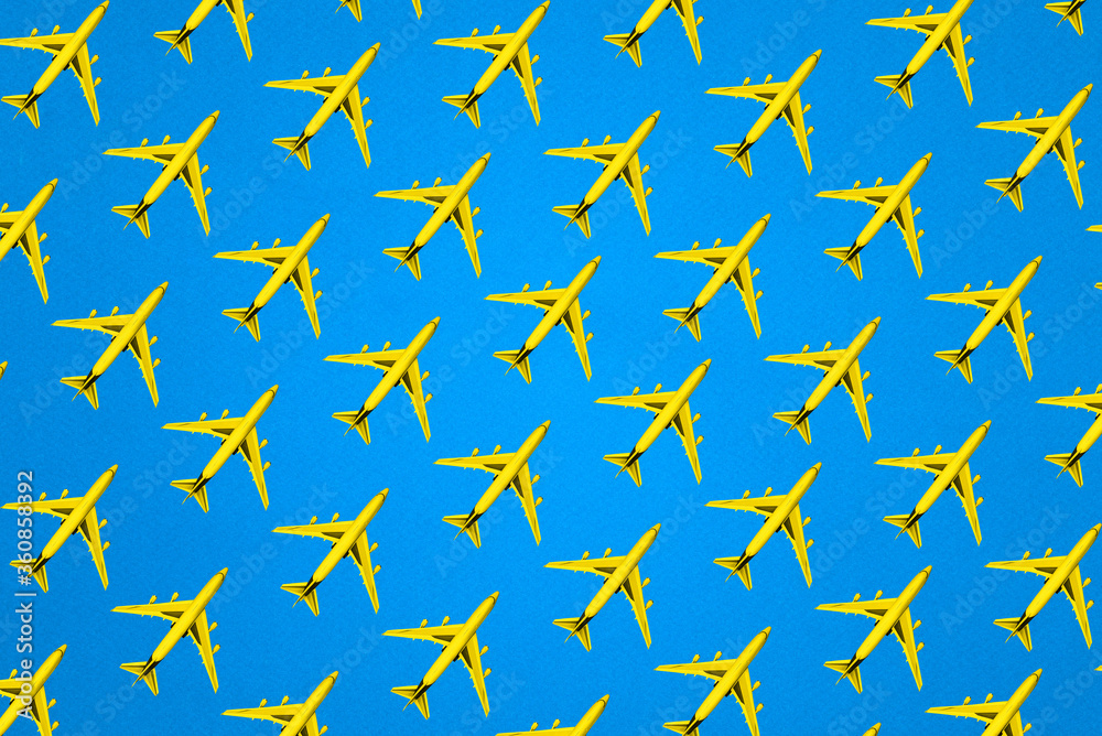 Model of a passenger plane on a blue background. Creative layout of the yellow plane. Minimal concept, travel and recreation. Model of a passenger plane on a blue background. Creative layout of the yellow plane. Minimal concept, travel and recreation.