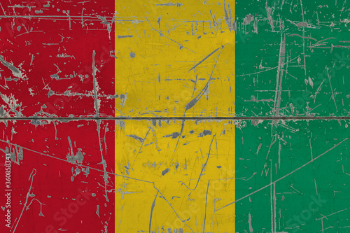 Guinea Bissau flag painted on cracked dirty surface. National pattern on vintage style surface. Scratched and weathered concept. © sezerozger