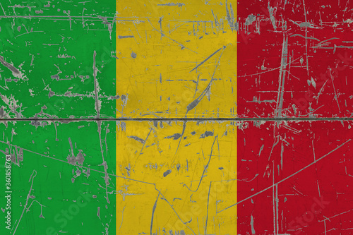 Mali flag painted on cracked dirty surface. National pattern on vintage style surface. Scratched and weathered concept. © sezerozger