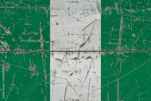 Nigeria flag painted on cracked dirty surface. National pattern on vintage style surface. Scratched and weathered concept. © sezerozger