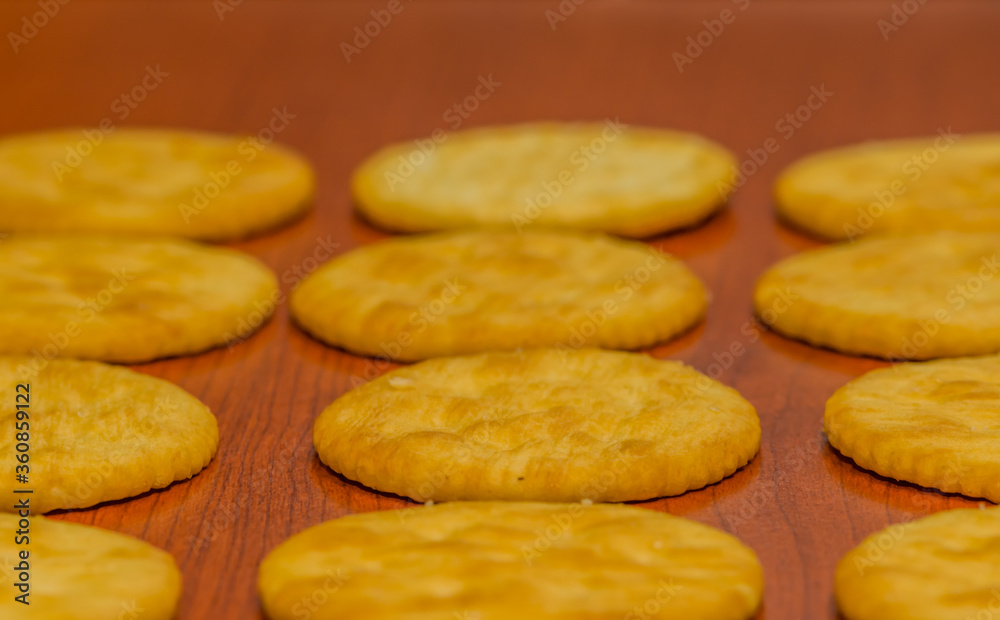 Round butter crackers on brown background. Round butter crackers on brown background.