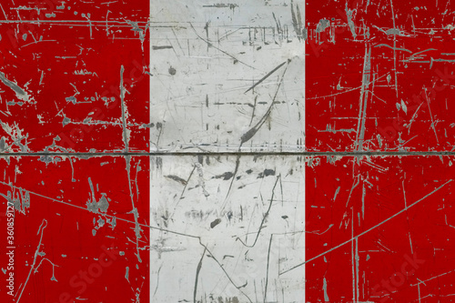 Peru flag painted on cracked dirty surface. National pattern on vintage style surface. Scratched and weathered concept. © sezerozger
