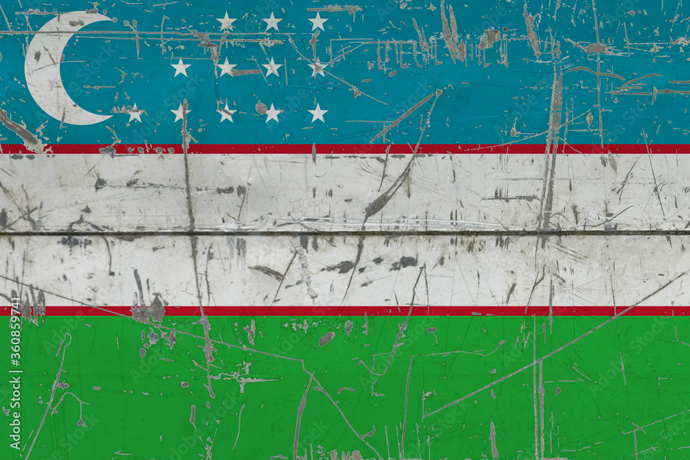 Uzbekistan flag painted on cracked dirty surface. National pattern on vintage style surface. Scratched and weathered concept.