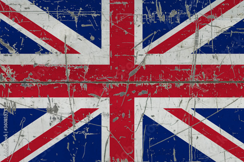 United Kingdom flag painted on cracked dirty surface. National pattern on vintage style surface. Scratched and weathered concept. photo