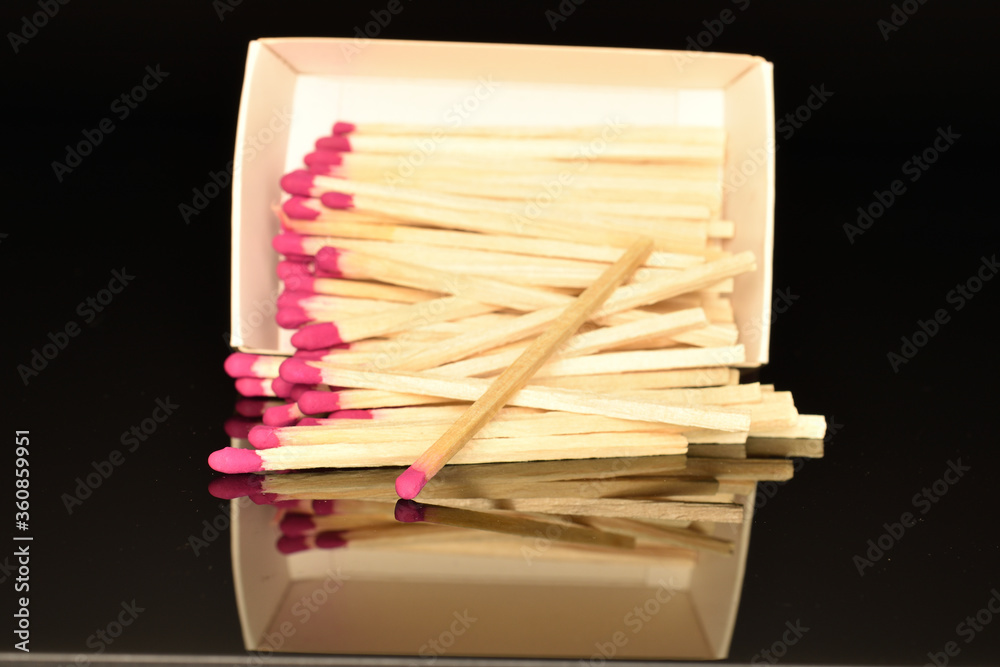 Matches made of wood, close-up, on a black background.