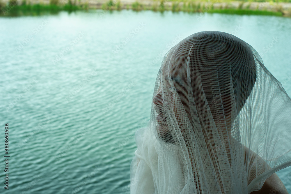 white net fabric cover on portrait bald beard man with summer natural blue lake water background white net fabric cover on portrait bald beard man with summer natural blue lake water background