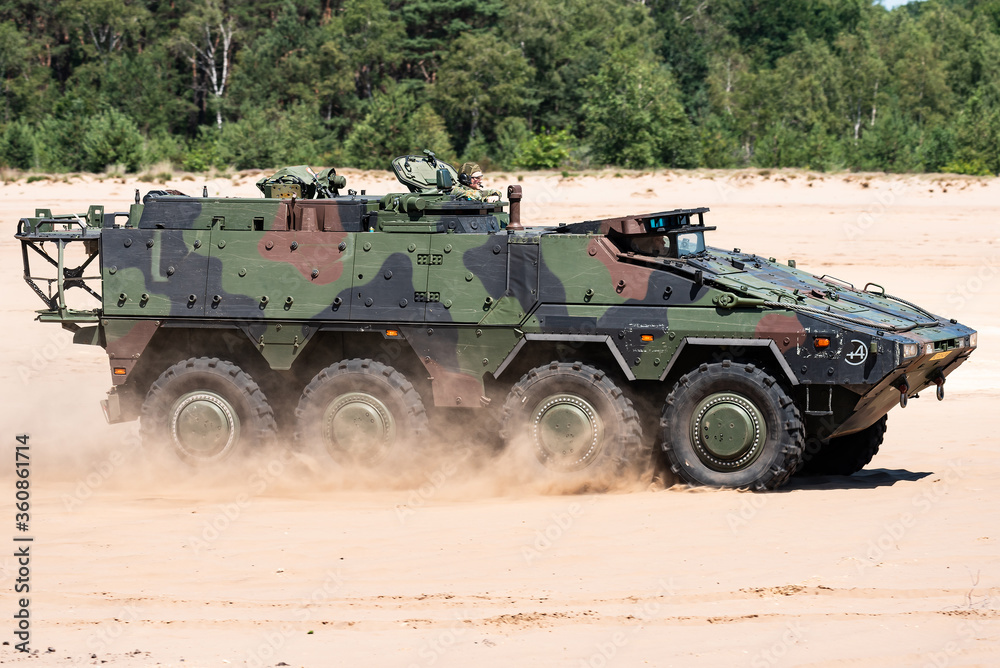 A Boxer military armoured fighting vehicle driving in the sand. 